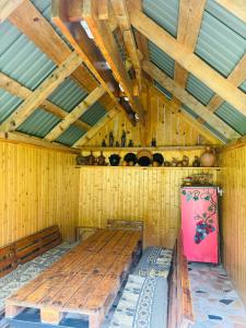 a room with two wooden benches in a house at DEDULETI დედულეთი in Ambrolauri