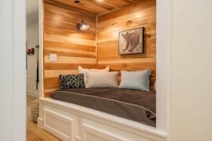 a bed in a room with wooden walls at Bear on the Lake in Oakland +84 photos