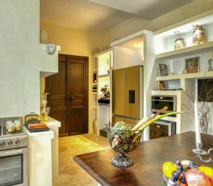 a kitchen with a table with a vase on it at Château de Lavail in Labastide-dʼAnjou