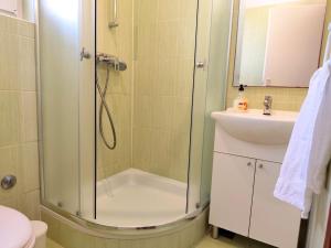 a bathroom with a shower and a sink at Apartments Pine in Primošten +32 photos