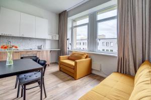 a living room with a yellow chair and a table at Value Stays - Code entry only, No staff in Vilnius
