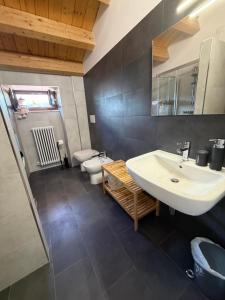 a bathroom with a sink and a toilet at La Piazzetta in LʼAquila +18 photos