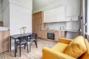 a living room with a yellow couch and a table at Value Stays - Code entry only, No staff in Vilnius +34 photos