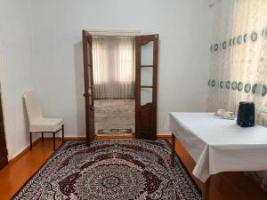 a room with a door and a table and a chair at Nur-Nomad in Balykchy +2 photos