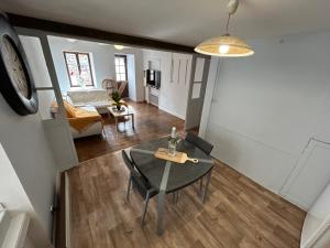 a dining table and chairs in a living room at Comme à La Maison in Cayres