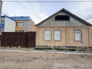 a house with a fence in front of it at Nur-Nomad in Balykchy