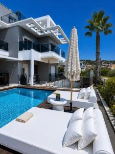 a villa with a swimming pool and a house at Allure villa in Porto Rafti