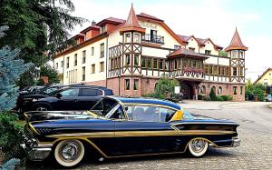 an old car parked in front of a building at Hotel Rebstock in Baden-Baden