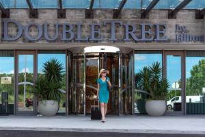 a woman walking in front of a doble tree building at Doubletree By Hilton Lagoa Azores in Lagoa +75 photos