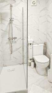 a white bathroom with a toilet and a shower at Limone Piemonte Kids Friendly in Limone Piemonte +18 photos