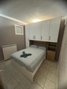 a bedroom with a bed with a green robe on it at La Casa di Maya a due passi da Sestriere in Grange Sises +35 photos
