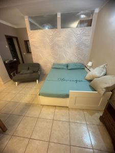 a bedroom with a bed and a couch at La Casa di Maya a due passi da Sestriere in Grange Sises
