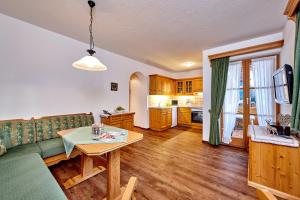 a living room with a couch and a table at Gästehaus Anneliese in Wallgau