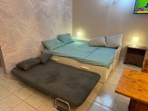 a bedroom with a bed with a ottoman and a table at La Casa di Maya a due passi da Sestriere in Grange Sises
