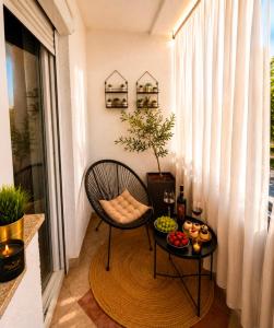 a balcony with a chair and a table with food on it at Apartment "Mimoza 1" self check-in, self check-out in Otočac