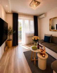 a living room with a couch and a table at Apartment "Mimoza 1" self check-in, self check-out in Otočac