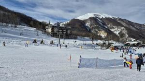a group of people skiing on a snow covered mountain at Limone Piemonte Kids Friendly in Limone Piemonte