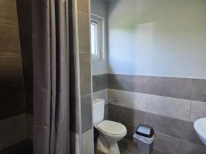 a bathroom with a toilet and a sink at Apartamenty u Bodzia in Stronie Śląskie +28 photos