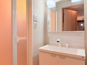 a bathroom with a sink and a mirror at LuxuryHOTEL難波南 in Osaka +43 photos