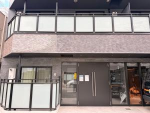 a building with glass windows and a revolving door at LuxuryHOTEL難波南 in Osaka