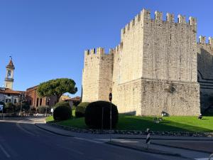 a large castle with a person standing in front of it at Casa Pallacorda in Prato +2 photos