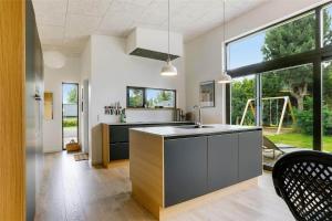 a kitchen with a sink and a large window at 30159-Odder-Thorasvej-24 in Odder
