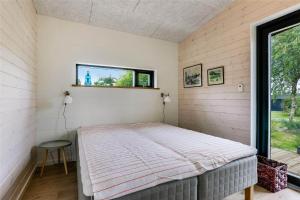 a bed in a room with a window at 30159-Odder-Thorasvej-24 in Odder