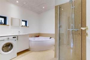 a bathroom with a shower and a washing machine at 30159-Odder-Thorasvej-24 in Odder +25 photos