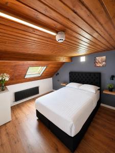 a bedroom with a large bed with a wooden ceiling at Hotel Albergo in Brussels