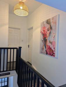 a painting of a woman on a wall at Ivy Townhouse Derry in Derry Londonderry