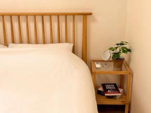 a bedroom with a bed and a plant on a night stand at Stay Joy in Suwon +25 photos