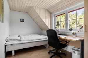 a bedroom with a bed and a desk and a chair at 1126-Ringkobing-Frans-Julius-Vej-44 in Klegod