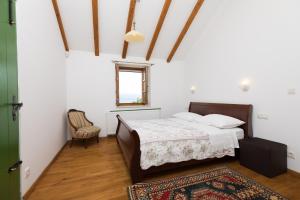 a bedroom with a bed and a window and a rug at Holiday Homes Baučić in Omiš +48 photos