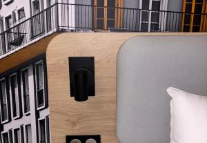 a bedroom with a building with a balcony at B&B HOTEL Le Havre Centre in Le Havre