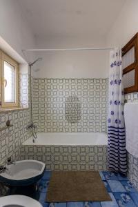 a bathroom with a tub and a toilet and a sink at Casa de Jonathan in Vilarinho do Souto +28 photos