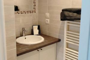 a bathroom with a sink and a mirror at Seaside house with cliff views in Piriac-sur-Mer