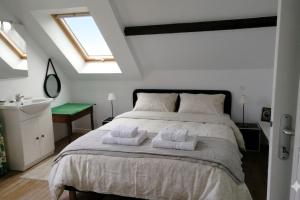 a bedroom with a large bed with two towels on it at Seaside house with cliff views in Piriac-sur-Mer