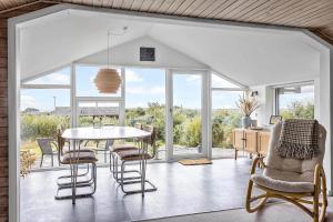 a dining room with a table and chairs at LF212-Vestervig-Ingersvej-12 in Vestervig