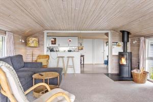 a living room with a couch and a fireplace at LF212-Vestervig-Ingersvej-12 in Vestervig +16 photos