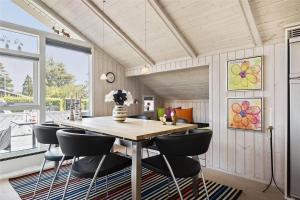 a dining room with a table and chairs at 30510-Odder-Elmegaardsvej-8 in Odder