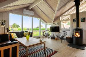a living room with a couch and a fireplace at 30510-Odder-Elmegaardsvej-8 in Odder