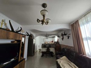 a living room with a couch and a chandelier at Nakra Tower GuestHouse in Mestia +46 photos