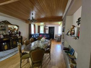 a dining room with a table and chairs at Nakra Tower GuestHouse in Mestia