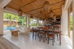 a dining room with a table and chairs at NEW Serenity Tropical 2 Bed Condo On Beachfront in Ban Saiyuan (1)
