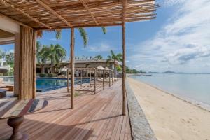 a view of the beach and pool at a resort at NEW Serenity Tropical 2 Bed Condo On Beachfront in Ban Saiyuan (1)