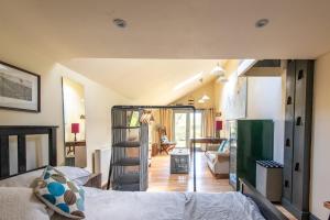a bedroom with a bed and a living room at The Forge, Snitterton near Matlock in Moffat