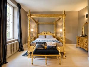 an ornate gold bedroom with a bed and a chair at Château de Lavail in Labastide-dʼAnjou +58 photos