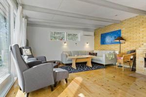 a living room with couches chairs and a table at 84100-Ebeltoft-Magevej-4 in Ebeltoft