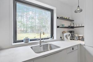 a kitchen with a sink and a window at 84100-Ebeltoft-Magevej-4 in Ebeltoft +28 photos