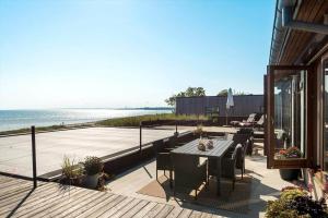 a patio with a table and chairs and the ocean at 8250-Ega-Strandvangsvej-52 in Egå